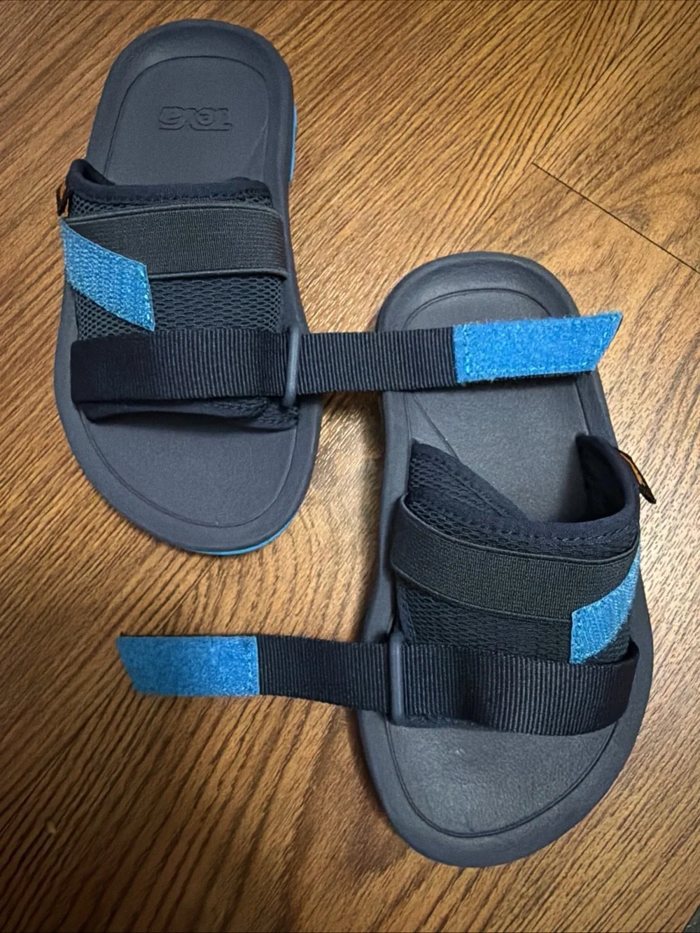 Teva Black Slide Sandals with Blue Accent